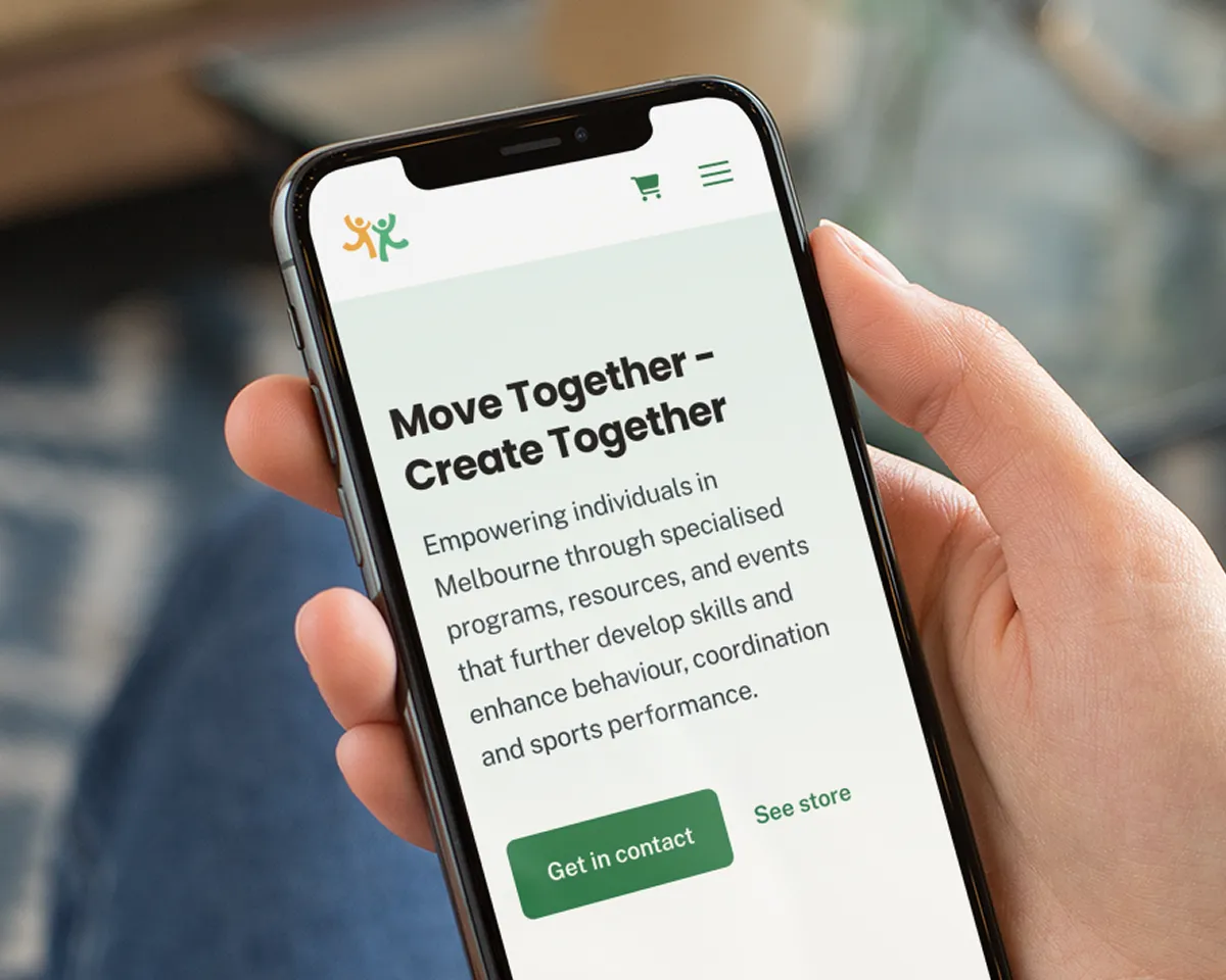 Woman holding a phone displaying the website